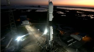 A SpaceX Falcon 9 rocket on the launch pad at sunset