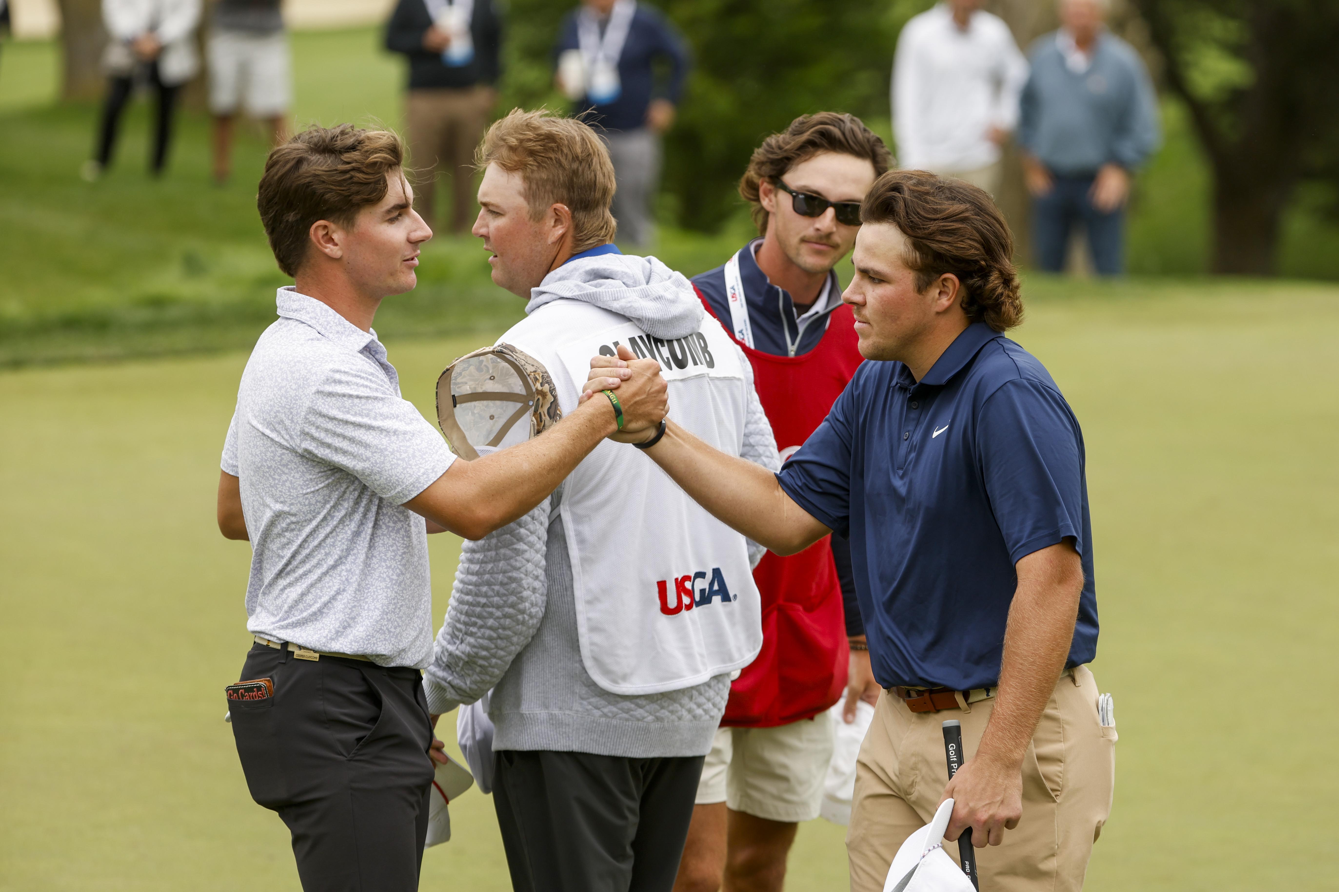 John Daly II shaking hands with his opponent at the US Amateur