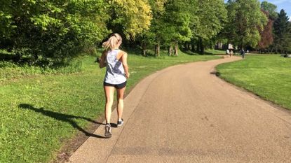 Woman running through a park