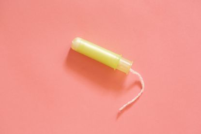 White female tampons on a pink background
