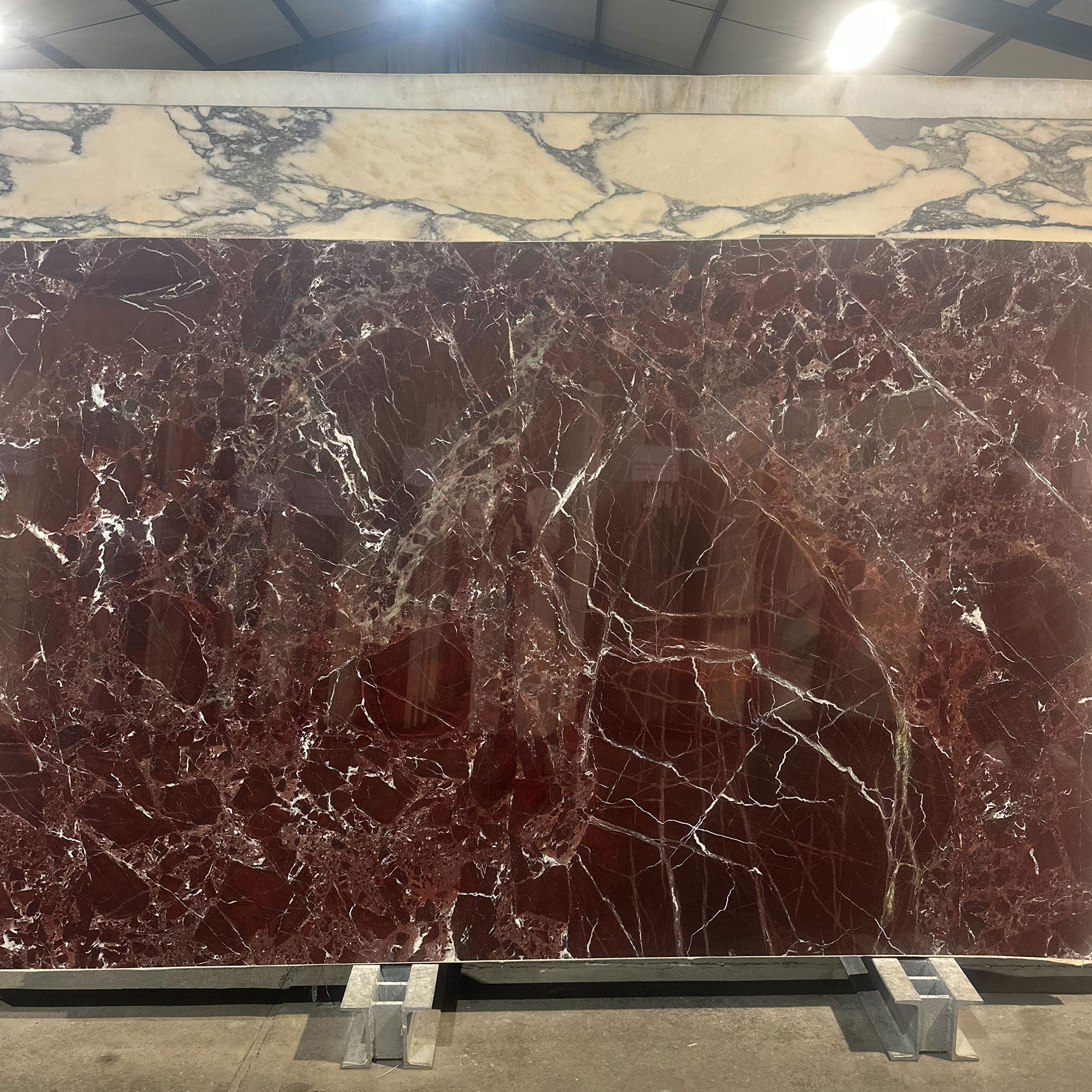 Large slab of deep red marble in warehouse