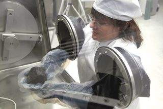 A scientist working in the Meteorite Processing Laboratory at NASA Johnson Space Center. I