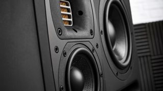 Close up of a ribbon tweeter and two woofers on a large studio monitor