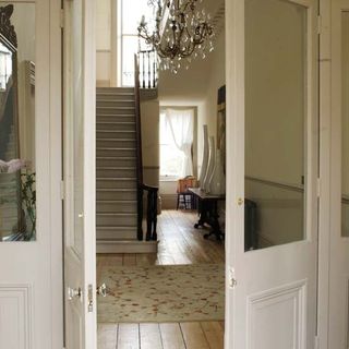hallway with white walls and staircase