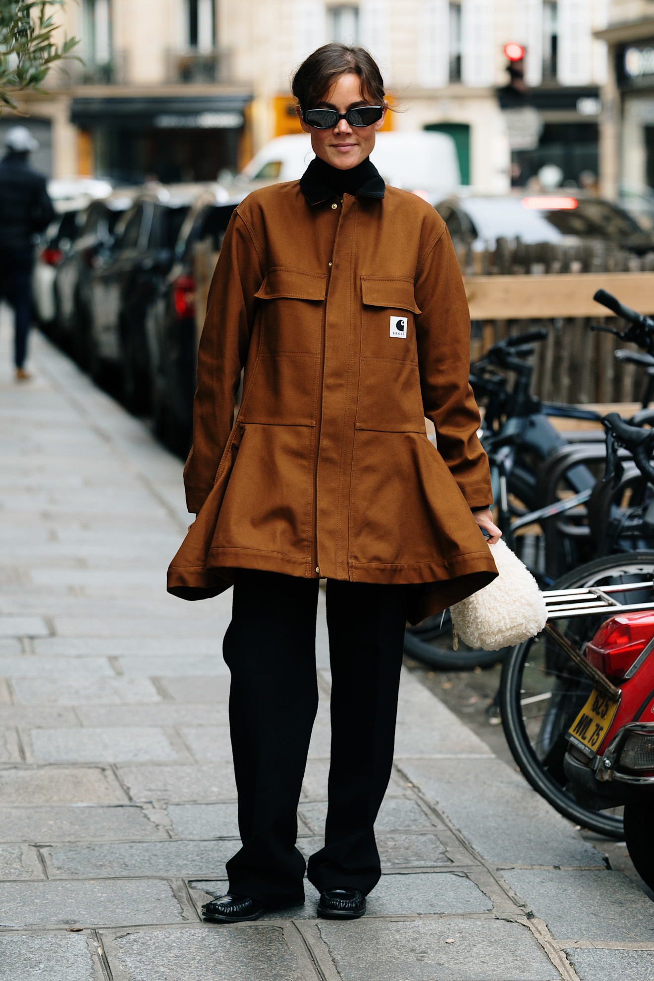 woman wearing a brown jacket and black trousers