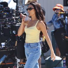 Shay Mitchell films the Baywatch reboot in Malibu wearing a yellow tank top and jeans