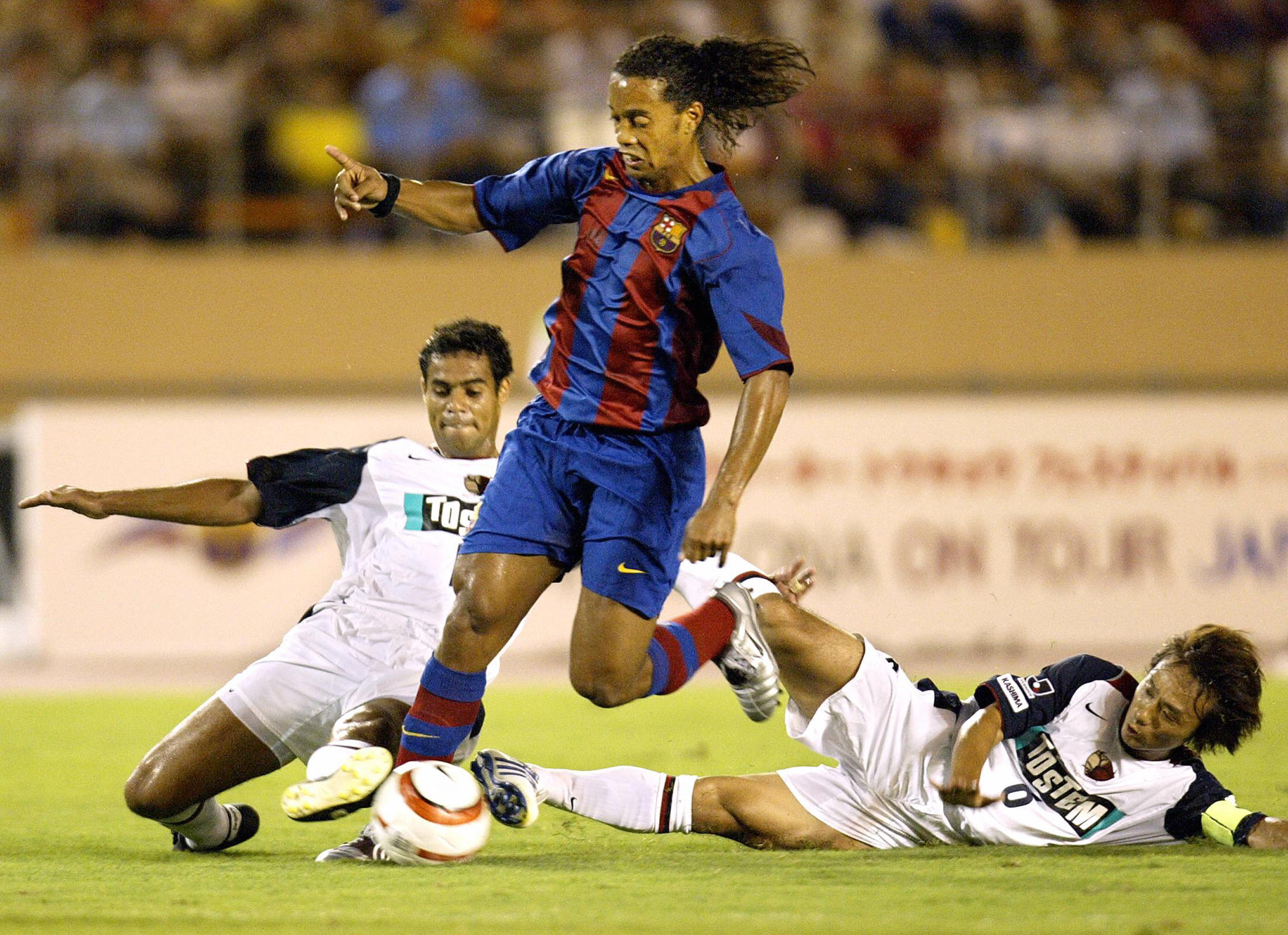 Barcelona's Ronaldinho runs with the ball in a friendly against Kashima Antlers in August 2004.