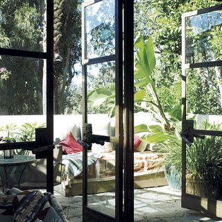 outdoor terrace with plants and cushions