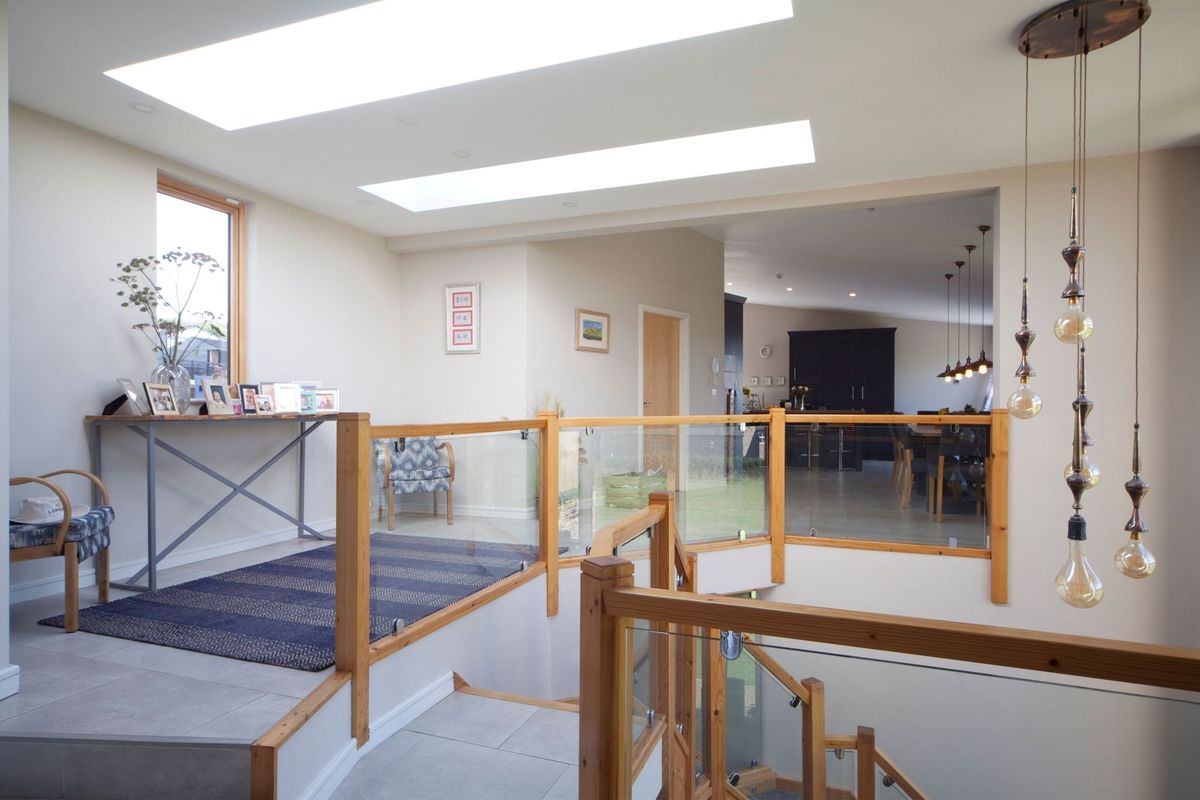 The top of the staircase with glass balustrade