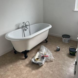 bathroom with roll top bath