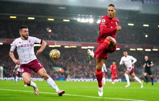 Aston Villa’s John McGinn (left) and Liverpool’s Virgil van Dijk battle for the ball during the Premier League match at Anfield, Liverpool. Picture date: Saturday December 11, 2021