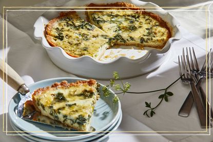 A spinach quiche in a dish with a slice taken out of it