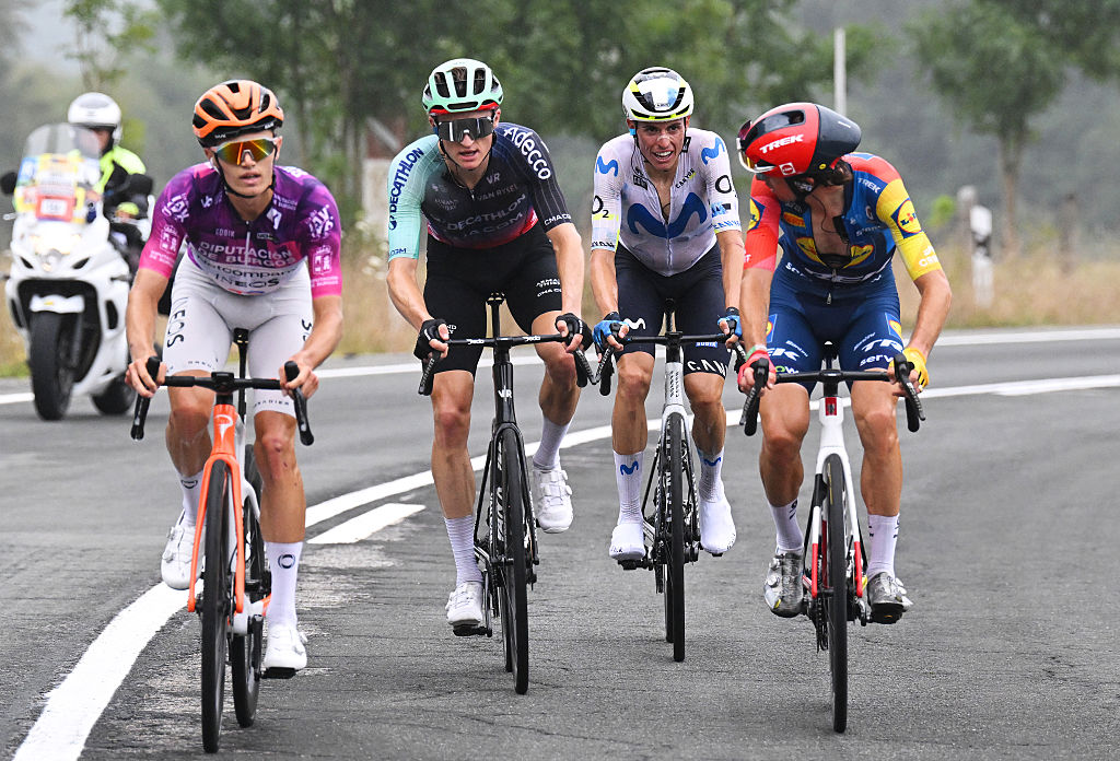 Four riders ride side by side