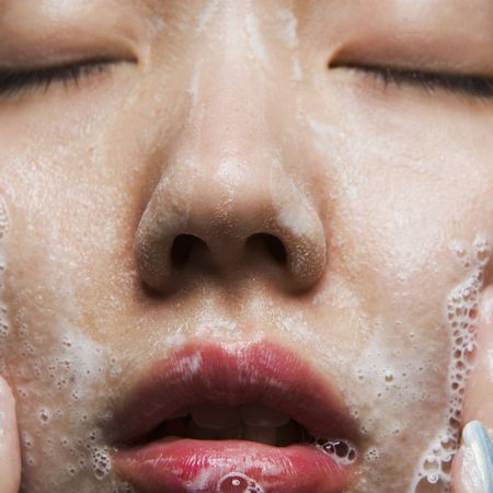 young woman washing face