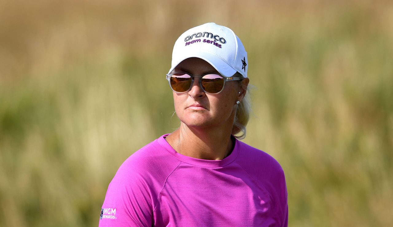 Nordqvist looks on while wearing sunglasses and a hat with Aramco on it