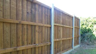 wooden fence with concrete fence posts