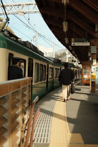 A man walking towards a train