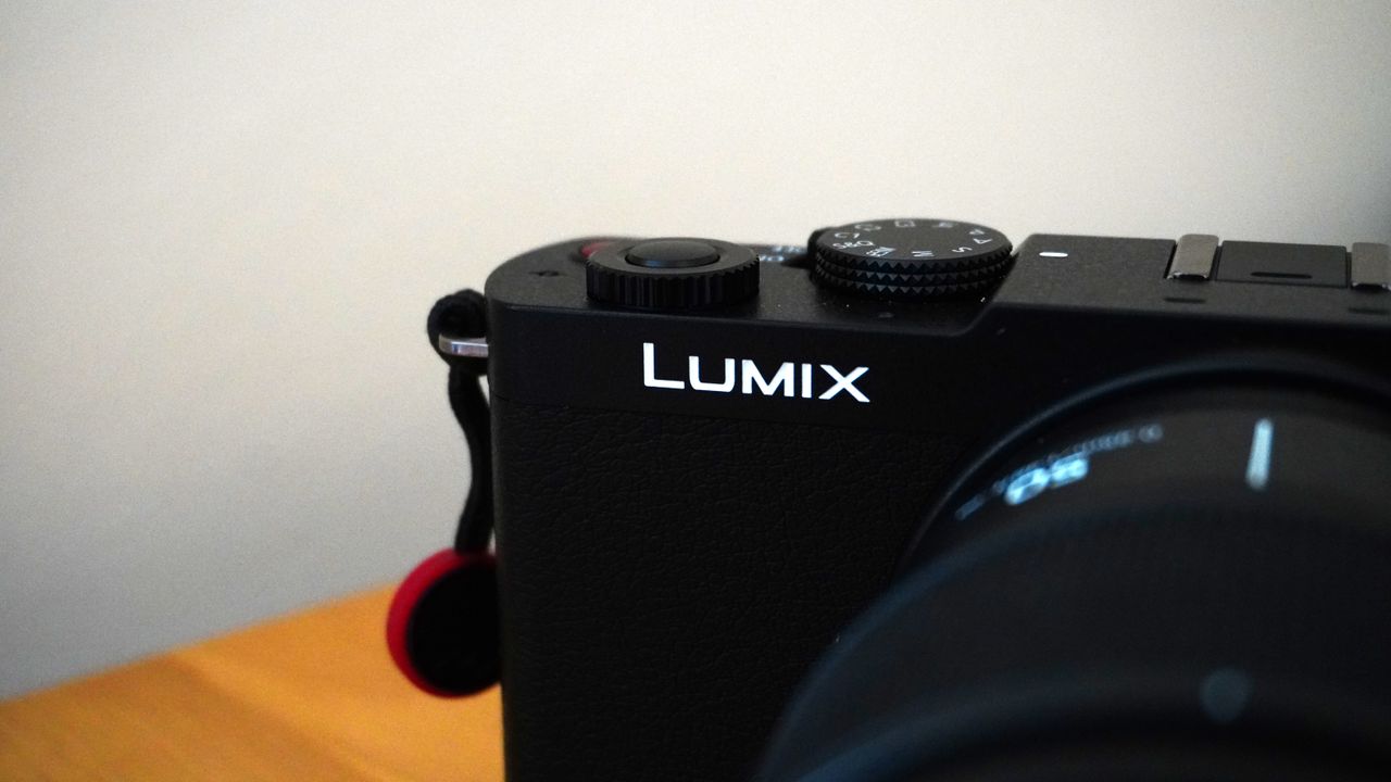 The Panasonic Lumix S9 on a wooden platform against a white background