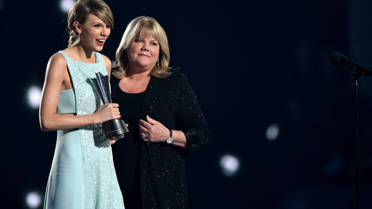 Honoree Taylor Swift (L) accepts the Milestone Award from Andrea Swift onstage during the 50th Academy Of Country Music Awards at AT&amp;T Stadium on April 19, 2015 in Arlington, Texas