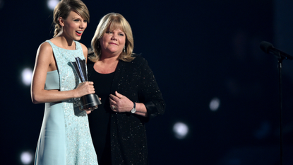 Honoree Taylor Swift (L) accepts the Milestone Award from Andrea Swift onstage during the 50th Academy Of Country Music Awards at AT&T Stadium on April 19, 2015 in Arlington, Texas