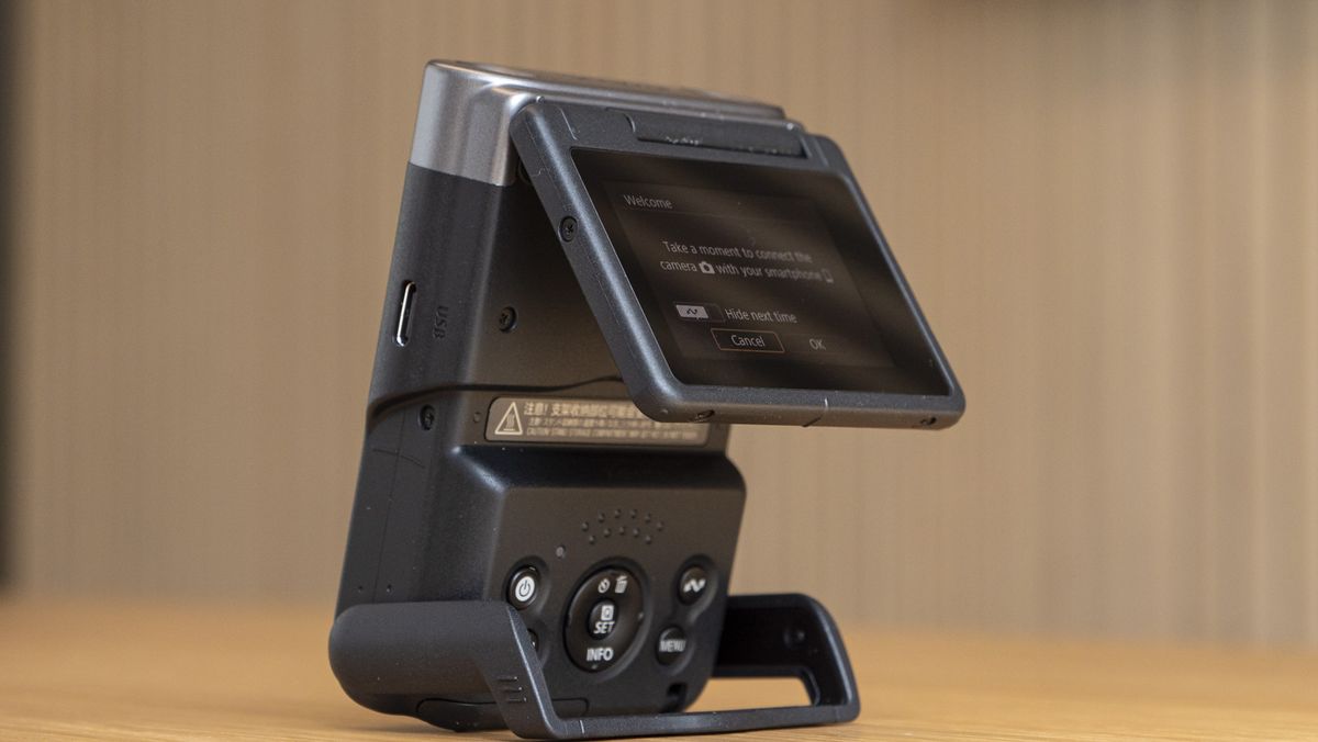 Canon Powershot V10 on a table with flipup screen partly out