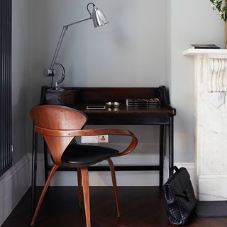 home office with black desk and chair with table lamp