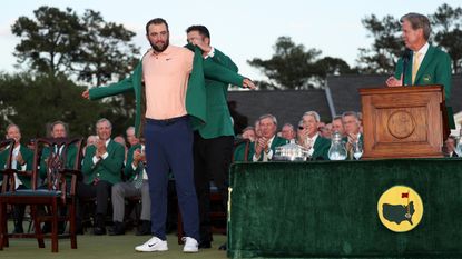 Scottie Scheffler receives the Green Jacket from Jon Rahm