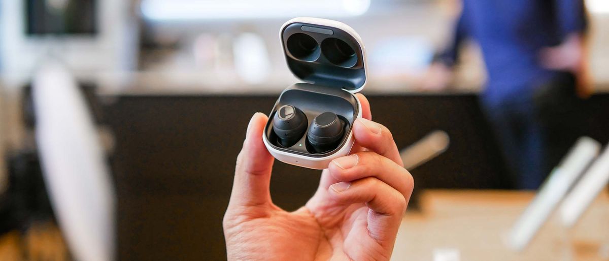 Samsung Galaxy Buds FE wireless earbuds held in the hand.