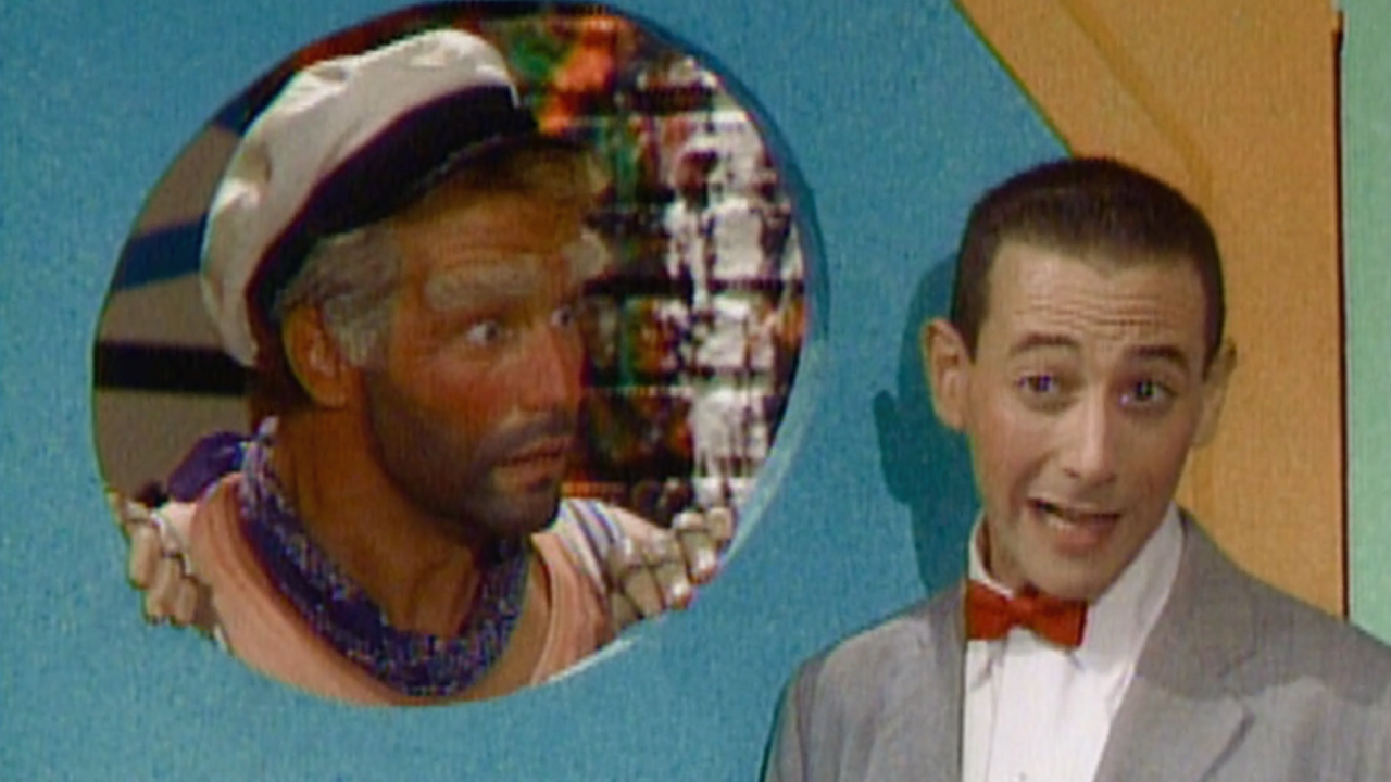 Phil Hartman as Captain Carl behind a door next to Paul Reubens as Pee-wee in The Pee-wee Herman Show