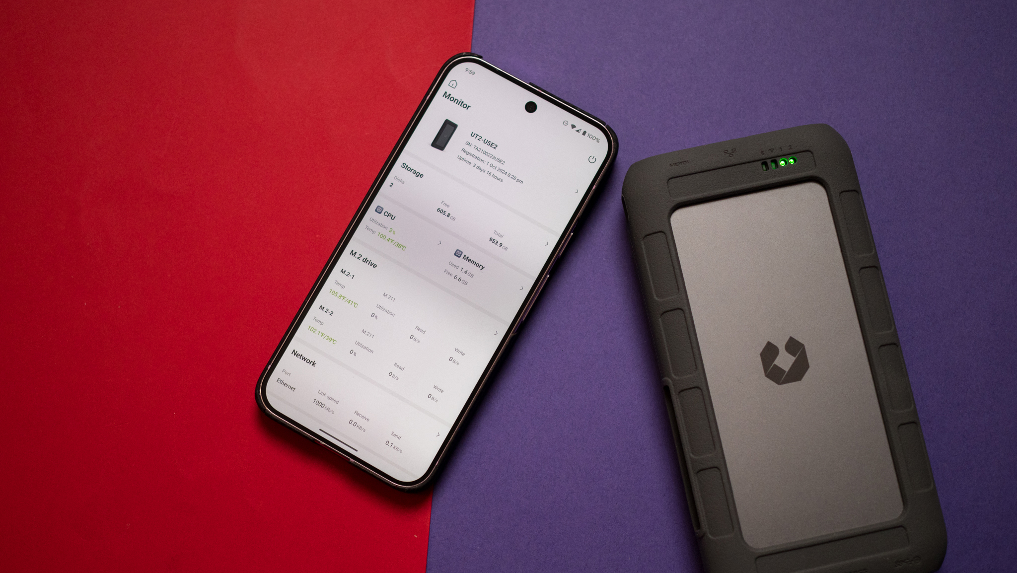 UnifyDrive UT2 NAS next to Pixel 9 Pro XL showing device stats