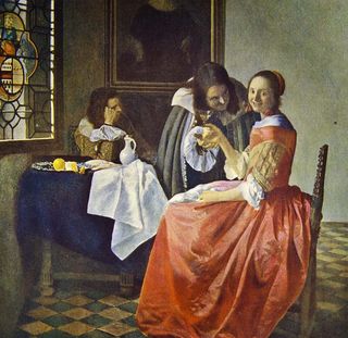 A reproduction of Johannes Vermeer's painting 'Girl with a glass.'