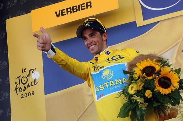 Alberto Contador delivers his 'six shooter' salute from the podium.