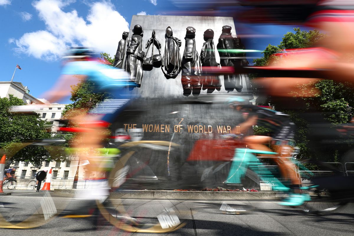 The peloton races past The Monument to the Women of World War II