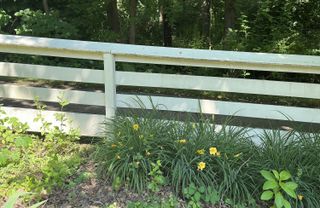white painted timber post and rail fence