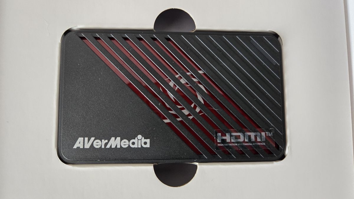 An AverMedia external capture card on a chair.