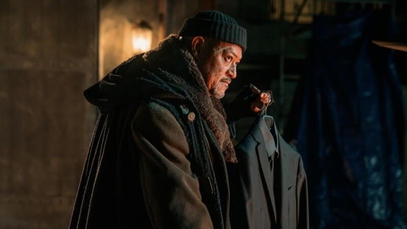Laurence Fishburne holding a suit in John Wick: Chapter 4