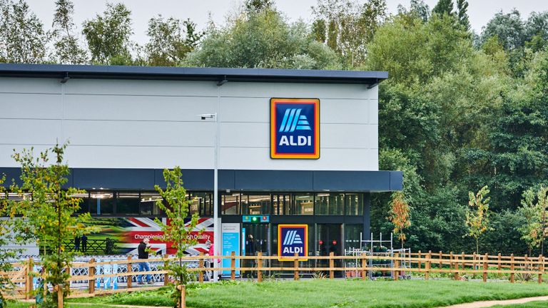 Aldi store exterior with grassy lawn and trees