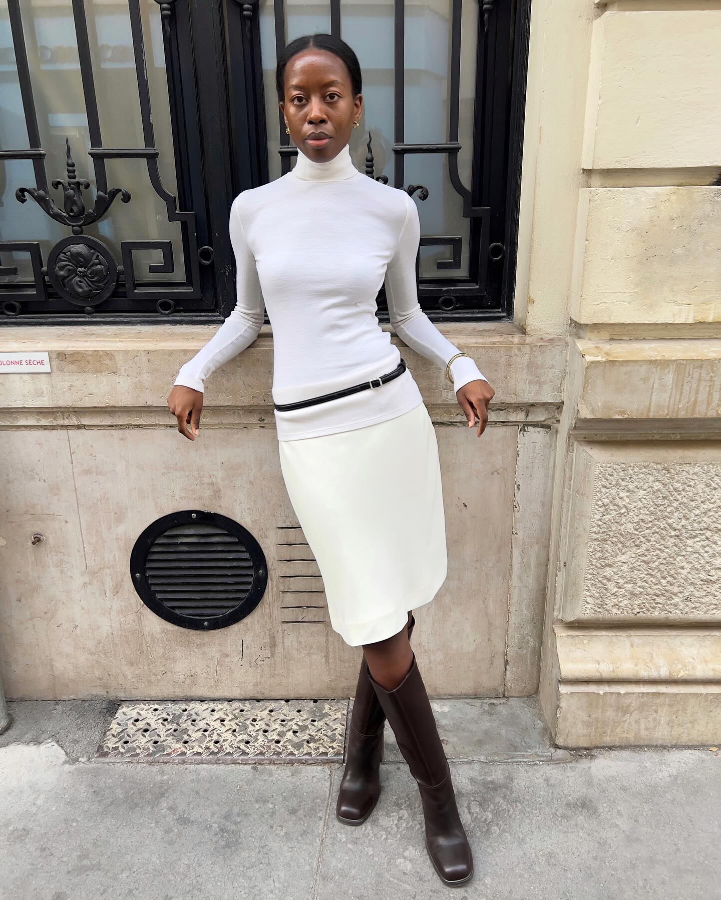 Sylvie Mus in a white pencil skirt and Vagabond boots