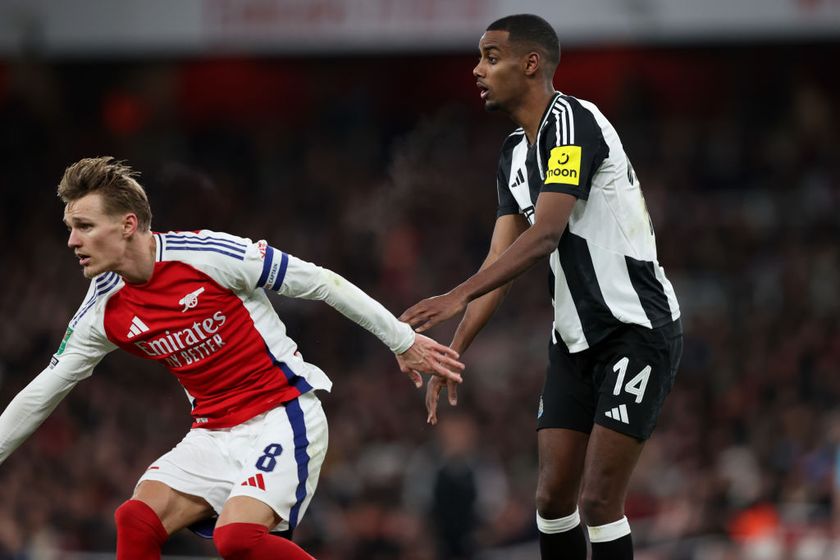 Martin Odegaard of Arsenal is pushed by Alexander Isak of Newcastle United before the opening goal during the Carabao Cup Semi Final First Leg match between Arsenal and Newcastle United at Emirates Stadium on January 7, 2025 in London, England.