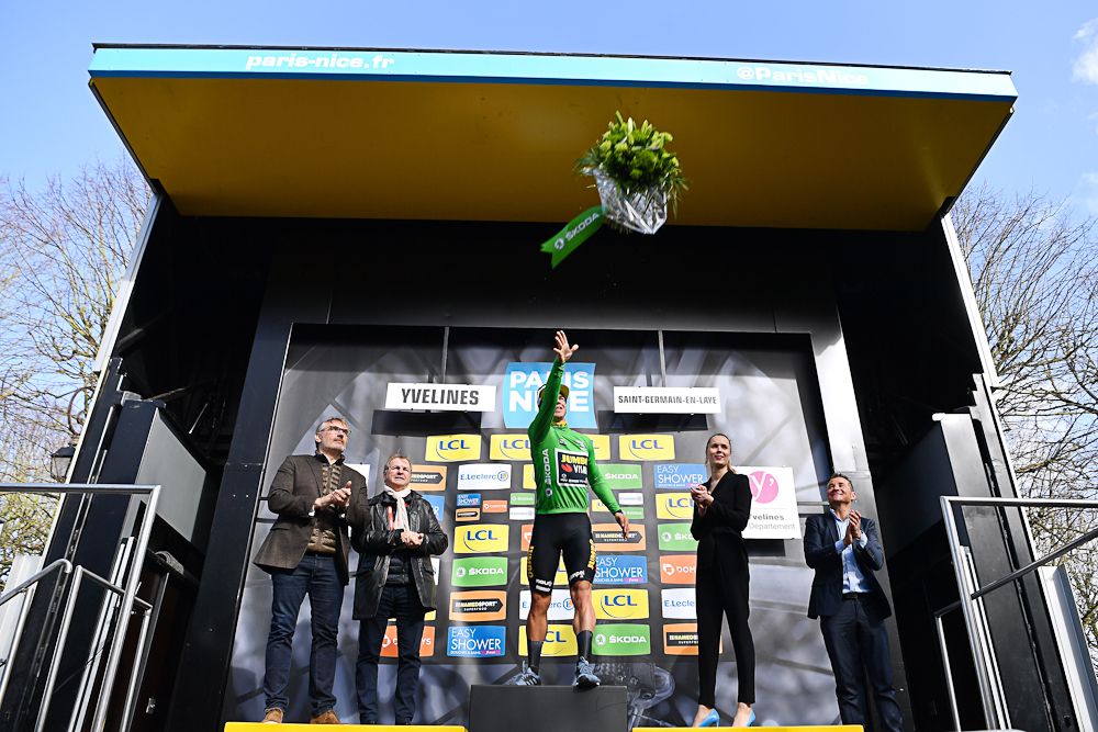 Dylan Groenewgen tosses a bouquet from the stage 1 podium at Paris-Nice