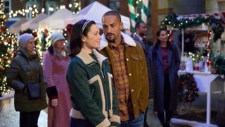 Italia Ricci, Michael Xavier walk through a Christmas market in Trading Up Christmas