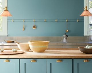 Teal traditional kitchen idea by Benjamin Moore with brass hooks