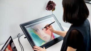 someone using a wacom drawing tablet