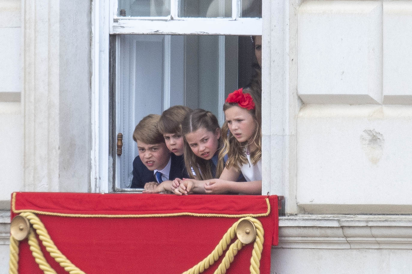 Princess Charlotte, Prince George and Prince Louis and Mia Tindall hanging out a window