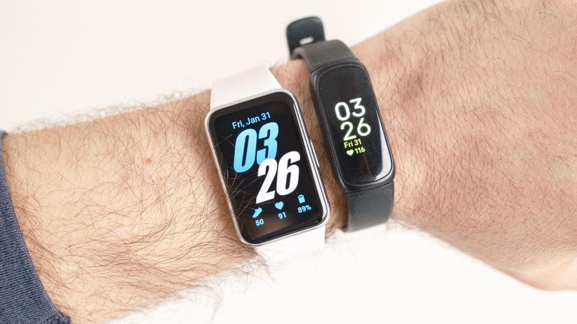 Close-up of the Samsung Galaxy Fit3 next to the Fitbit Inspire 3 in a user&#039;s hand