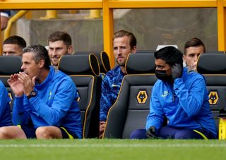 Tottenham Hotspur’s Harry Kane (centre) sits on the bench ahead of the Premier League match at the Molineux Stadium, Wolverhampton. Picture date: Sunday August 22, 2021