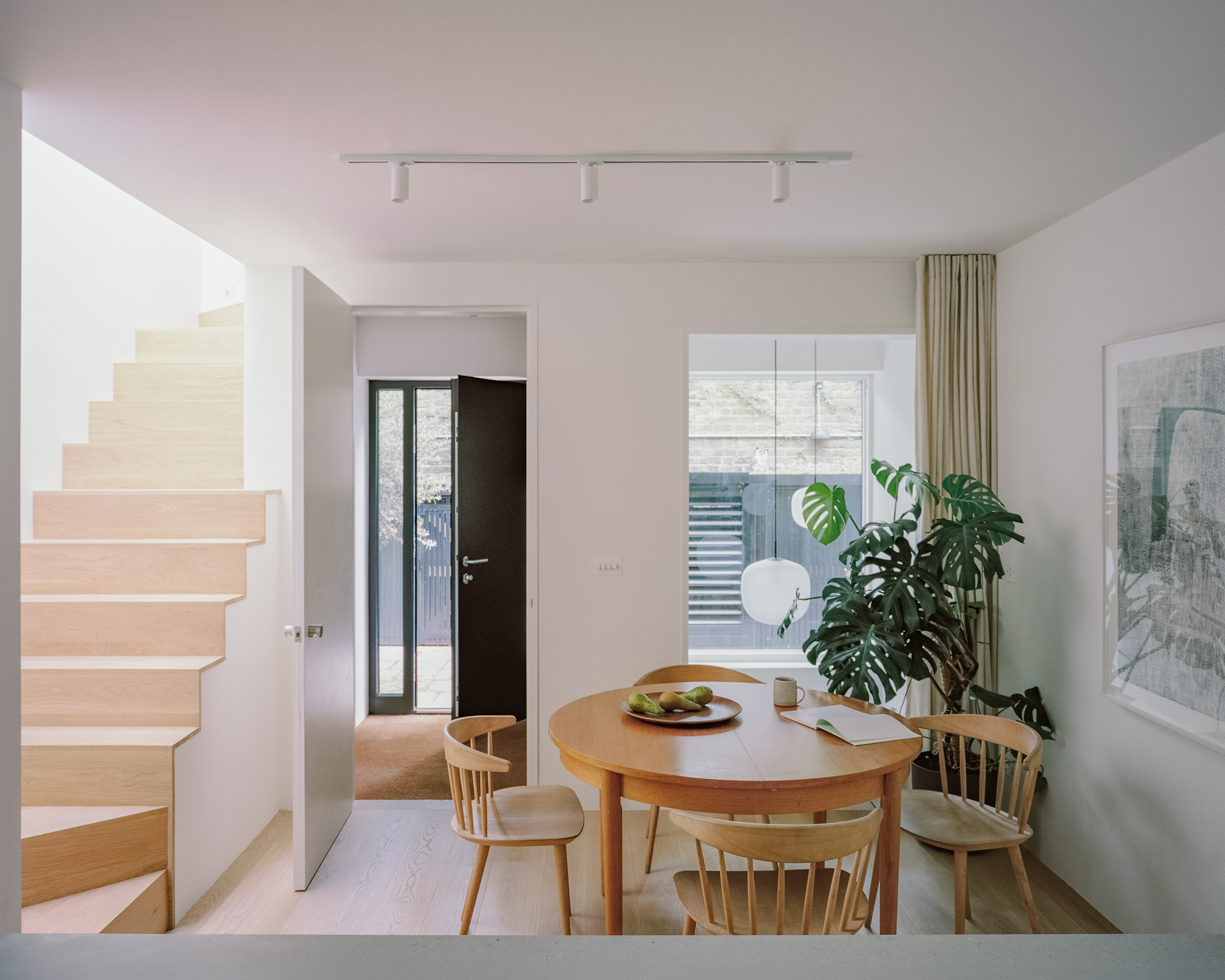 The house opens up onto a dining room and kitchen at ground floor level