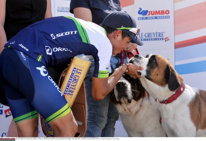 Johan Esteban Chaves says hello to the podium dogs