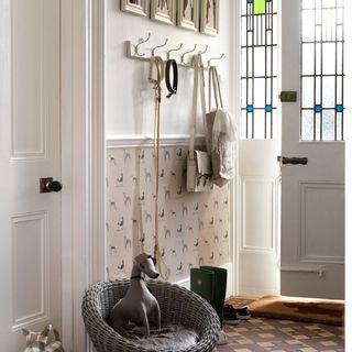 hallway with white door and artisan chair with handbag on hooks