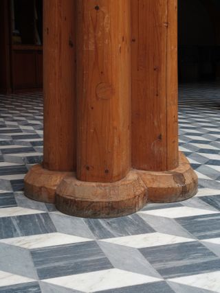 Close up of detail on the bottom of wooden pillar